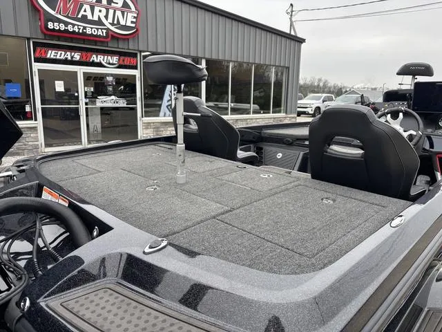 Slide: The Image of 2024 Nitro Z21 XL Pro boat at dealership, showcasing spacious deck and seating. - 3