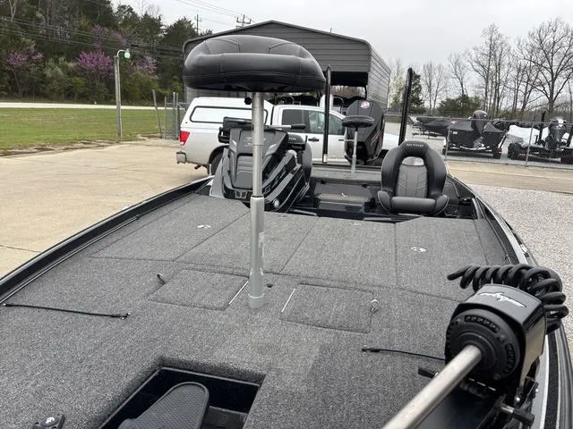 Slide: The Image of 2024 Nitro Z21 XL Pro fishing boat with seating and trolling motor, parked outdoors. - 9