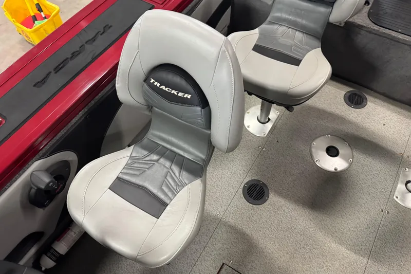 Slide: The Image of 2019 Tracker Targa V-19 Combo boat interior with gray seats and red trim. - 7