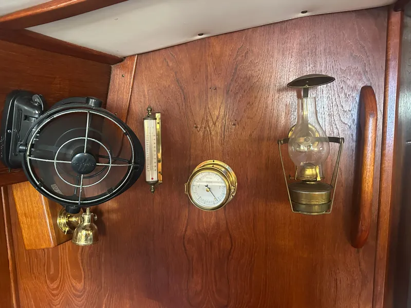 Slide: The Image of 1980 Morgan 382 interior with vintage fan, barometer, and lantern on wooden panel. - 11
