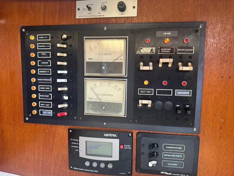 Slide: The Image of Electrical control panel on a 1980 Morgan 382 sailboat, featuring gauges and switches. - 13