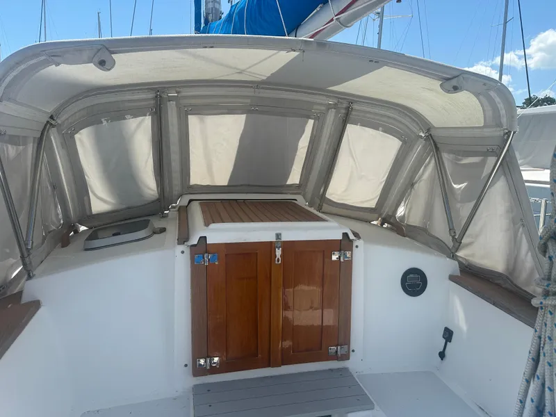 Slide: The Image of 1980 Morgan 382 sailboat cockpit with wooden doors and protective canopy. - 14