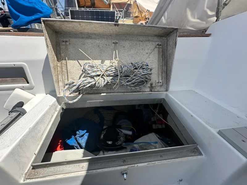 Slide: The Image of Open storage compartment on 1980 Morgan 382 sailboat with ropes and gear inside. - 17