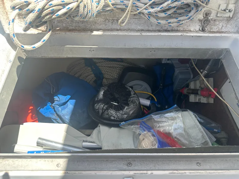 Slide: The Image of Storage compartment on a 1980 Morgan 382 sailboat, filled with ropes and equipment. - 18