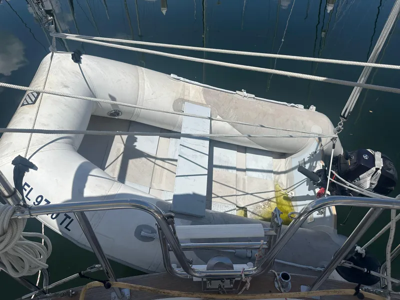 Slide: The Image of Inflatable dinghy on a 1980 Morgan 382 sailboat, docked with visible railing and ropes. - 19