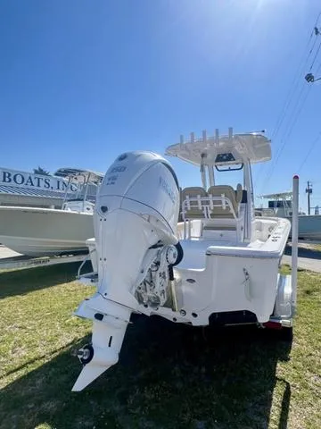 Slide: The Image of 2025 Sportsman Masters 247 boat with outboard motor, displayed outdoors on grass. - 13