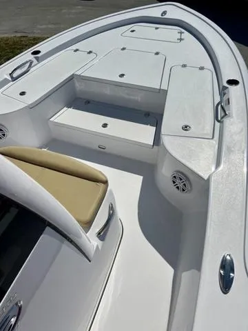 Slide: The Image of 2025 Sportsman Masters 247 boat interior with white seating and storage compartments. - 14