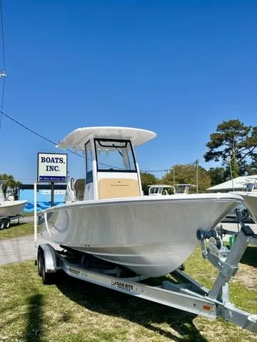 Slide: The Image of 2025 Sportsman Masters 247 boat on trailer at dealership under clear blue sky. - 19