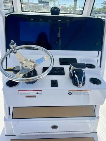 Slide: The Image of 2025 Sportsman Masters 247 boat dashboard with steering wheel and control panel. - 4