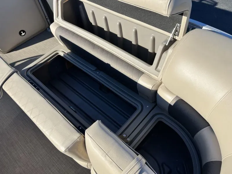 Slide: The Image of 2021 Sun Tracker PARTY BARGE® 20 DLX storage compartment with open seat revealing spacious interior. - 11