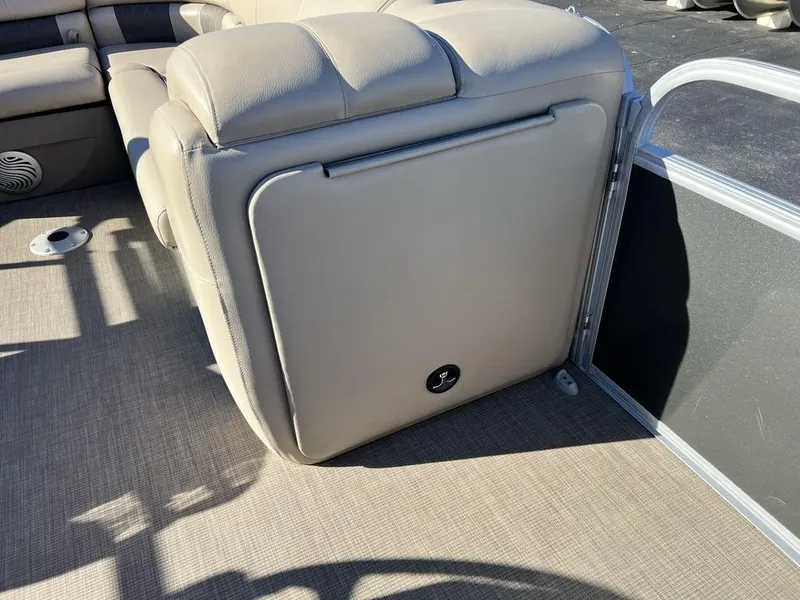 Slide: The Image of 2021 Sun Tracker PARTY BARGE® 20 DLX interior seating with beige upholstery and storage compartment. - 13