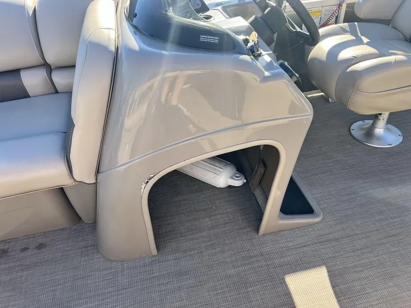 Slide: The Image of 2021 Sun Tracker PARTY BARGE® 20 DLX interior with beige seating and helm console. - 15