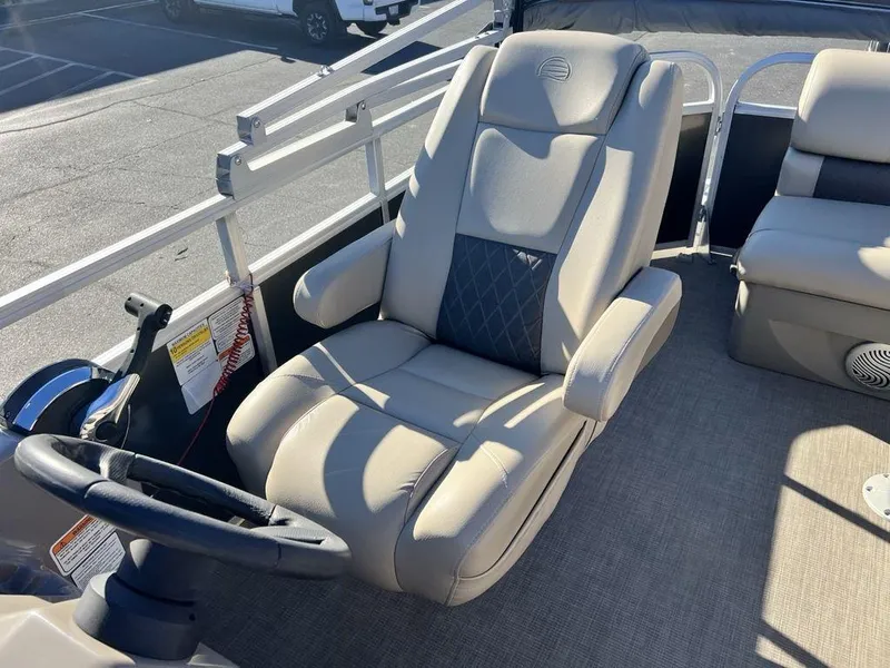 Slide: The Image of 2021 Sun Tracker PARTY BARGE® 20 DLX captain's chair in a pontoon boat. - 16