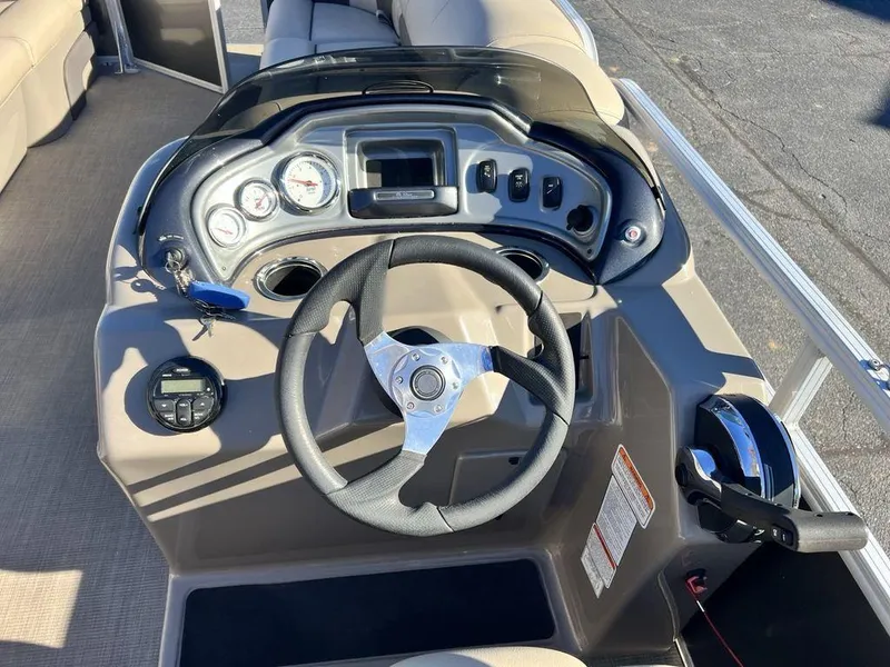 Slide: The Image of 2021 Sun Tracker PARTY BARGE® 20 DLX boat dashboard with steering wheel and controls. - 17