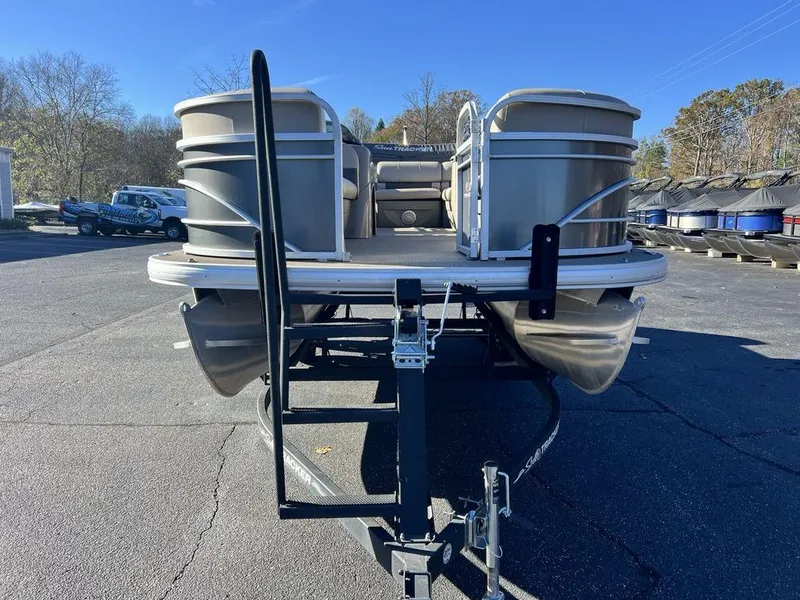 Slide: The Image of 2021 Sun Tracker PARTY BARGE® 20 DLX pontoon boat on trailer in parking lot. - 4