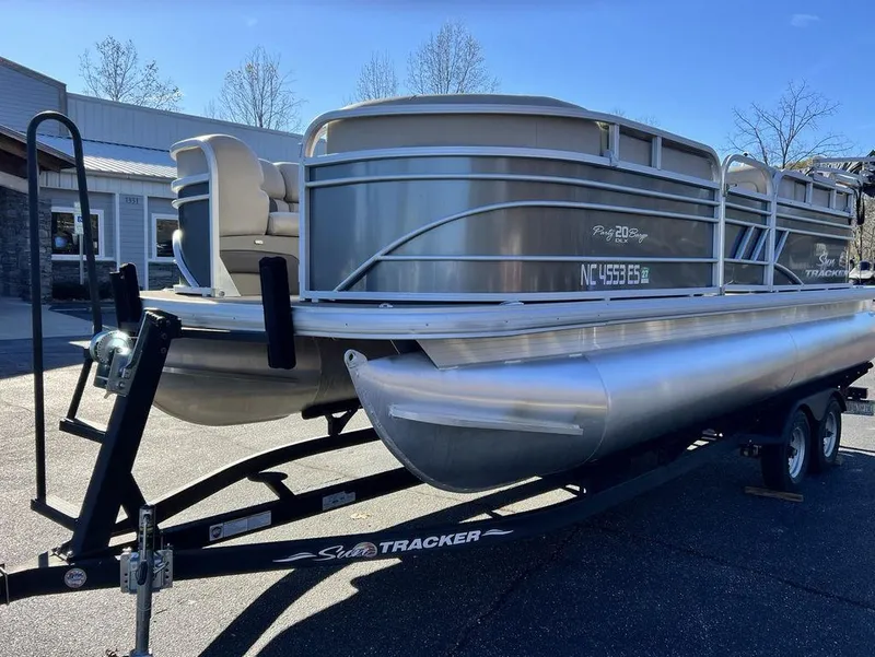 Slide: The Image of 2021 Sun Tracker PARTY BARGE® 20 DLX pontoon boat on trailer, parked outdoors. - 5