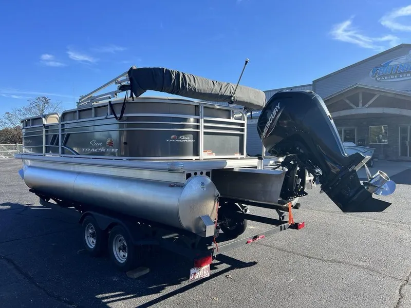 Slide: The Image of 2021 Sun Tracker PARTY BARGE® 20 DLX pontoon boat on trailer, parked outdoors. - 6