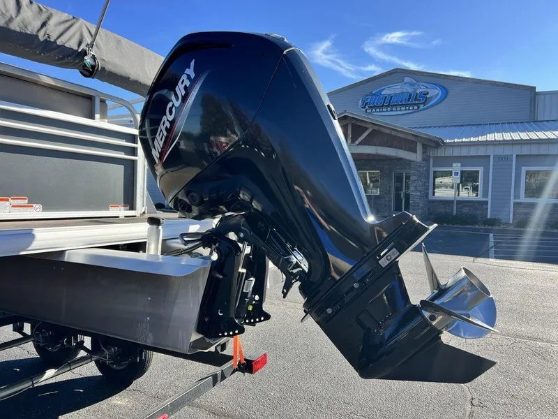 Slide: The Image of 2021 Sun Tracker PARTY BARGE® 20 DLX with Mercury outboard motor in a dealership lot. - 8