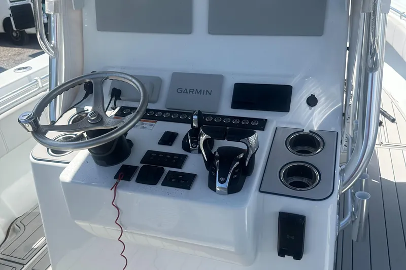 Slide: The Image of 2023 Contender 32 ST boat console with Garmin navigation and modern controls. - 10