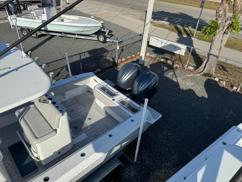 Slide: The Image of 2023 Contender 32 ST boat with dual outboard motors, docked on a sunny day. - 21