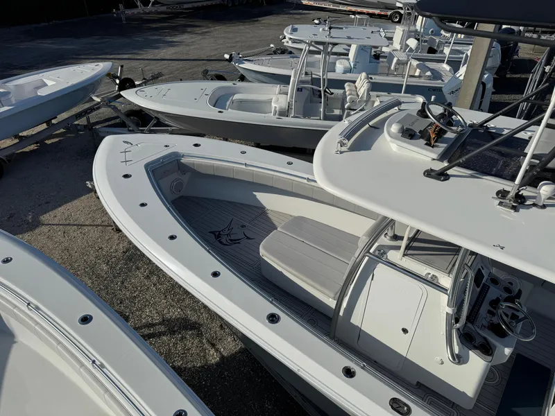 Slide: The Image of 2023 Contender 32 ST boats displayed in a marina, showcasing sleek design and modern features. - 22