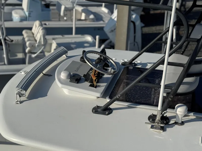 Slide: The Image of 2023 Contender 32 ST boat helm with steering wheel and controls. - 24