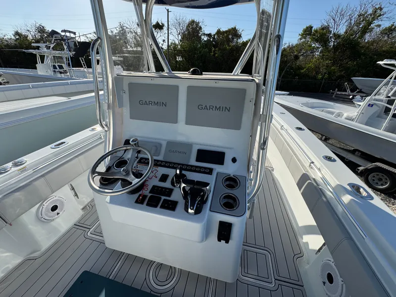 Slide: The Image of 2023 Contender 32 ST boat console with dual Garmin displays and steering wheel. - 32