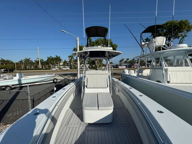 Slide: The Image of 2023 Contender 32 ST boat with sleek design, docked under clear blue sky. - 37