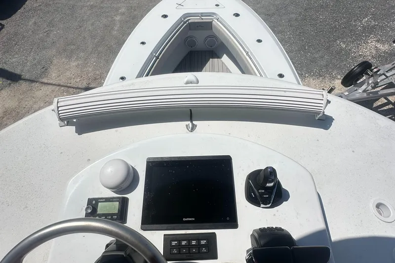 Slide: The Image of 2023 Contender 32 ST boat dashboard with navigation controls and display. - 4