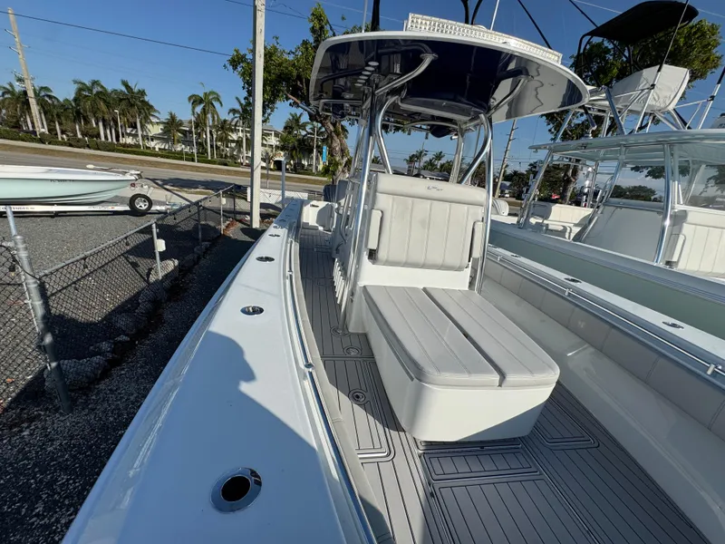 Slide: The Image of 2023 Contender 32 ST boat with sleek design and spacious seating, docked outdoors. - 40