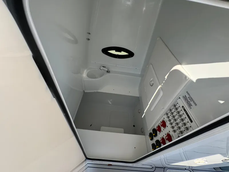 Slide: The Image of 2023 Contender 32 ST boat interior compartment with control panel and porthole. - 42