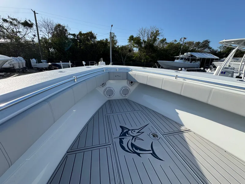 Slide: The Image of 2023 Contender 32 ST boat interior with marlin design on deck, surrounded by seating. - 46