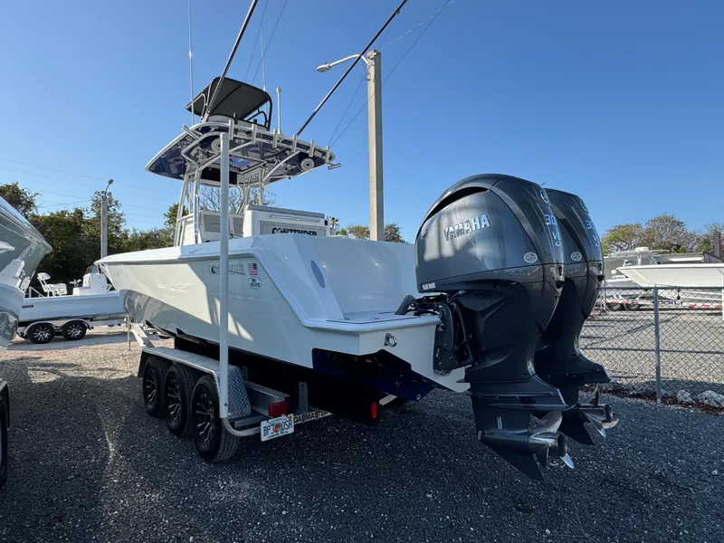 Slide: The Image of 2023 Contender 32 ST boat with dual Yamaha engines on a trailer. - 47