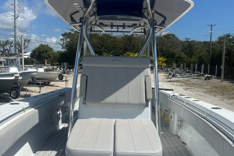 Slide: The Image of 2023 Contender 32 ST boat with sleek seating and modern design in a sunny outdoor setting. - 5