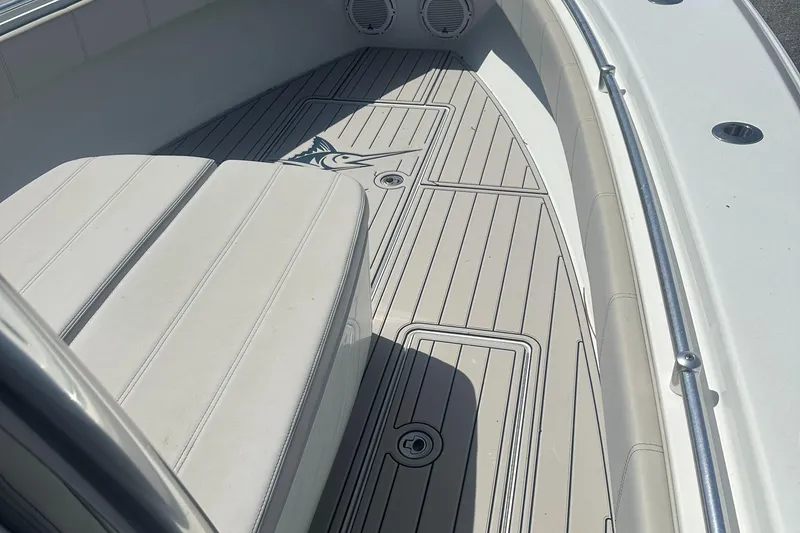 Slide: The Image of 2023 Contender 32 ST boat interior with cushioned seating and sleek deck design. - 6