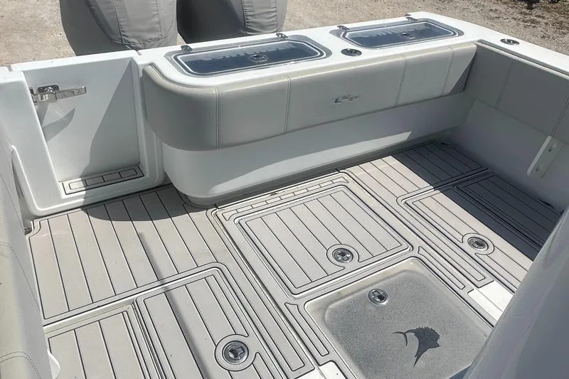 Slide: The Image of 2023 Contender 32 ST boat deck with storage compartments and cushioned seating. - 8