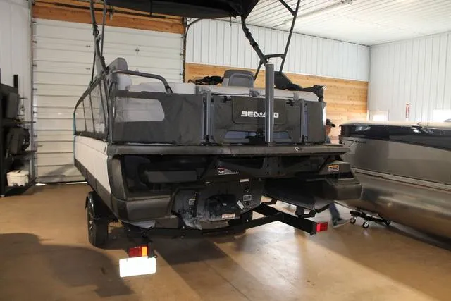 Slide: The Image of 2022 Sea-Doo Switch Sport 18, 230 hp, in a garage setting, rear view. - 3