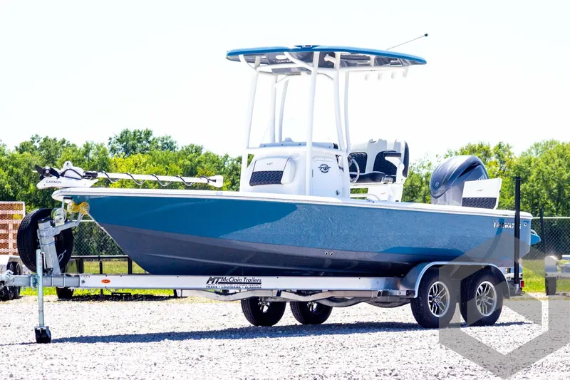 Slide: The Image of 2025 Tidewater 2110 Bay Max boat on trailer, blue hull, outdoor setting. - 1