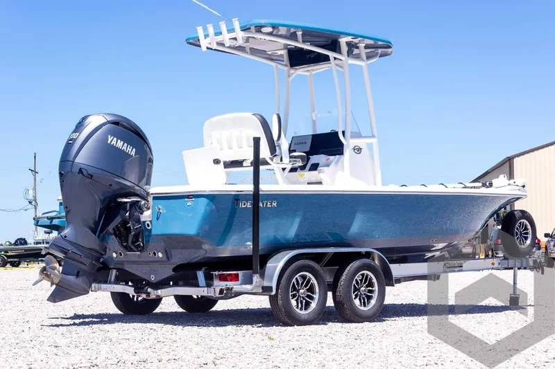 Slide: The Image of 2025 Tidewater 2110 Bay Max boat on trailer with Yamaha engine, parked outdoors. - 13