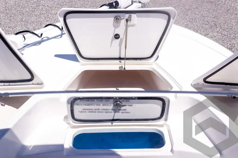Slide: The Image of 2025 Tidewater 2110 Bay Max boat storage compartments and livewell, open view. - 24