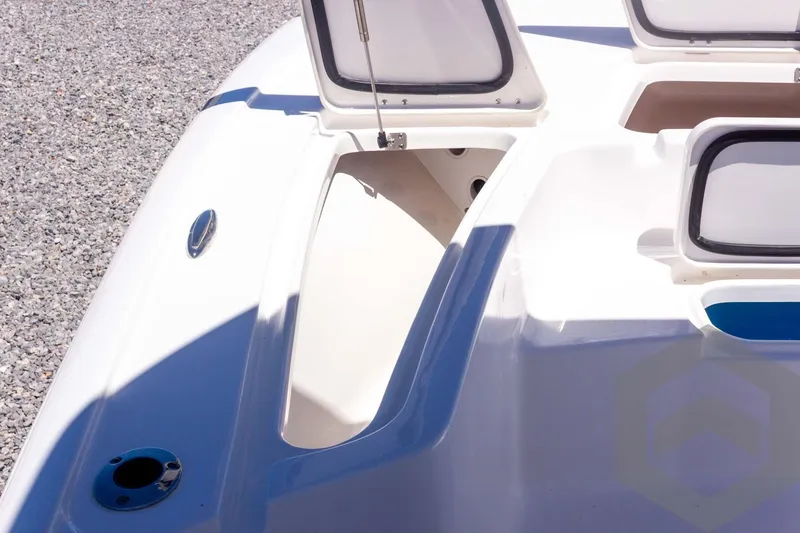 Slide: The Image of 2025 Tidewater 2110 Bay Max boat storage compartments on a sunny day. - 25