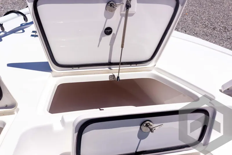 Slide: The Image of 2025 Tidewater 2110 Bay Max boat storage compartment open, showcasing spacious interior. - 26
