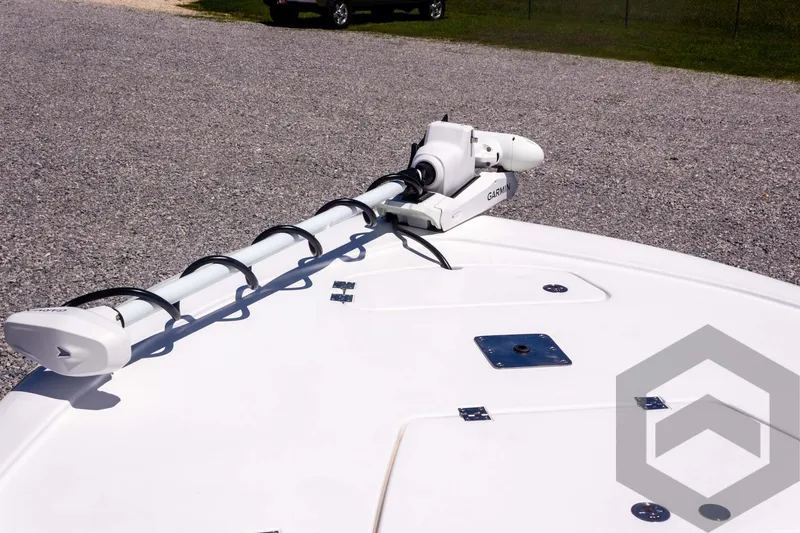 Slide: The Image of 2025 Tidewater 2110 Bay Max boat with mounted trolling motor on gravel surface. - 29