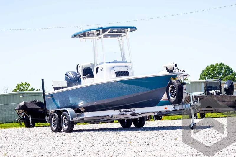 Slide: The Image of 2025 Tidewater 2110 Bay Max boat on trailer, parked outdoors on gravel. - 3
