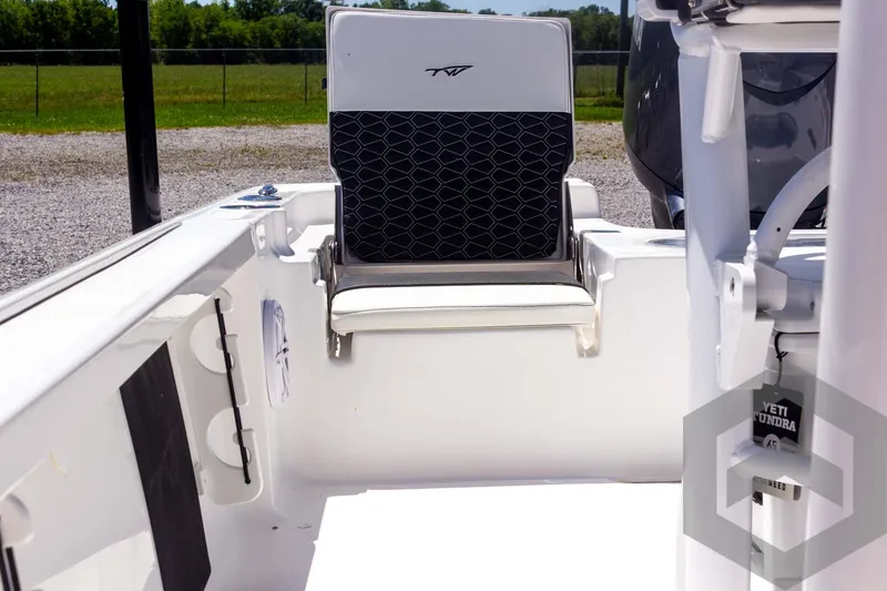 Slide: The Image of 2025 Tidewater 2110 Bay Max boat interior with seating and storage compartments. - 32