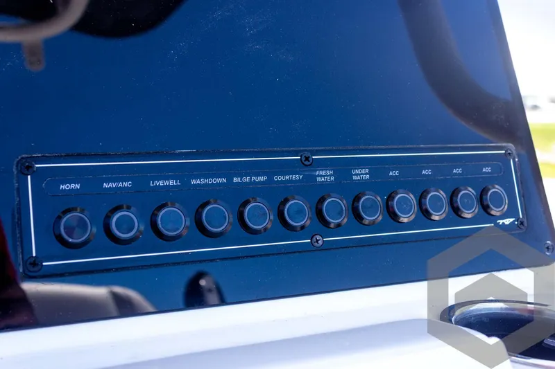 Slide: The Image of Control panel of 2025 Tidewater 2110 Bay Max boat with labeled switches. - 38