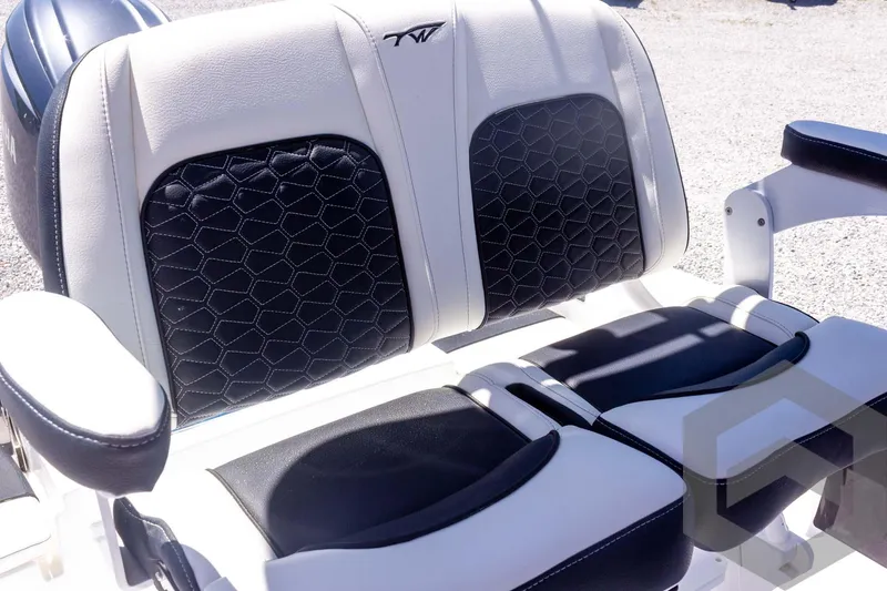 Slide: The Image of 2025 Tidewater 2110 Bay Max boat seats with black and white upholstery, featuring hexagonal patterns. - 42