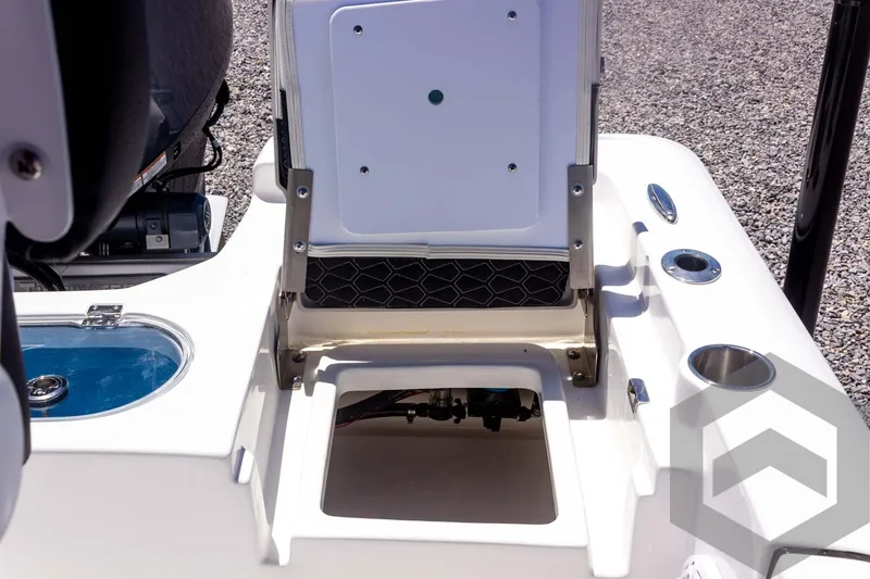 Slide: The Image of 2025 Tidewater 2110 Bay Max boat interior with storage compartment and cup holders. - 48