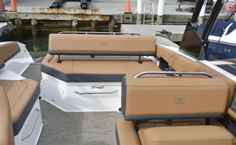 Slide: The Image of 2022 Cobalt R6 boat interior with tan seating at a marina. - 11