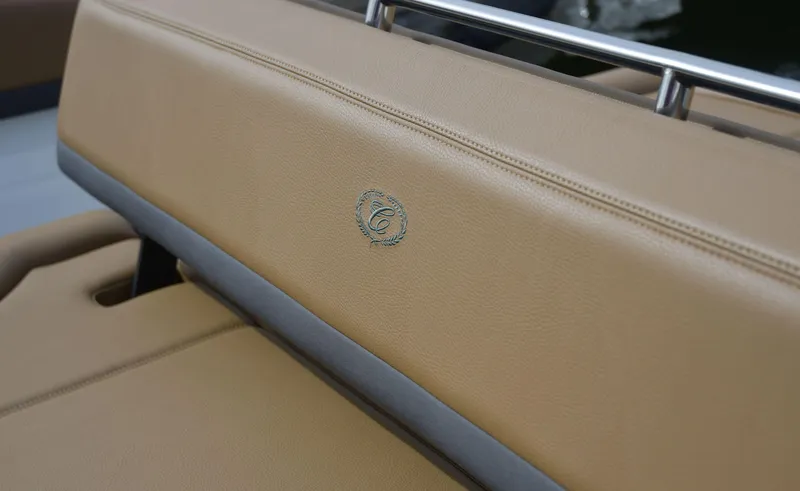 Slide: The Image of 2022 Cobalt R6 boat seat with tan leather upholstery and logo detail. - 12